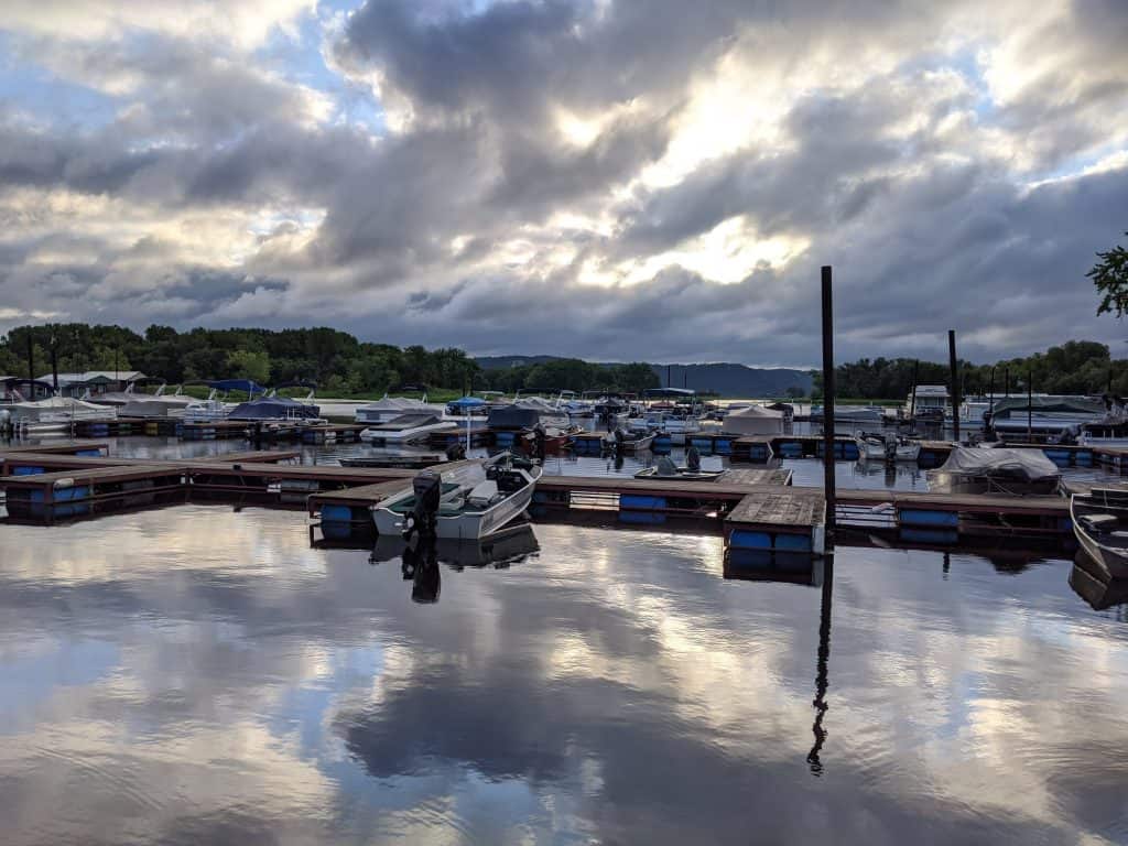 motionless water at marina, reflecting the clouds and sky above.