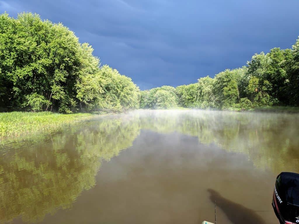 landscape image of upper Mississippi river backwater. bass fishing in the rain before during and after a storm