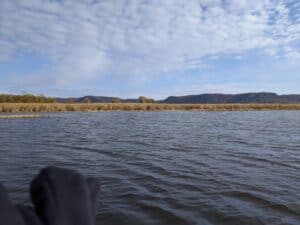 September bass fishing on the Mississippi River, landscape image with bluffs in background