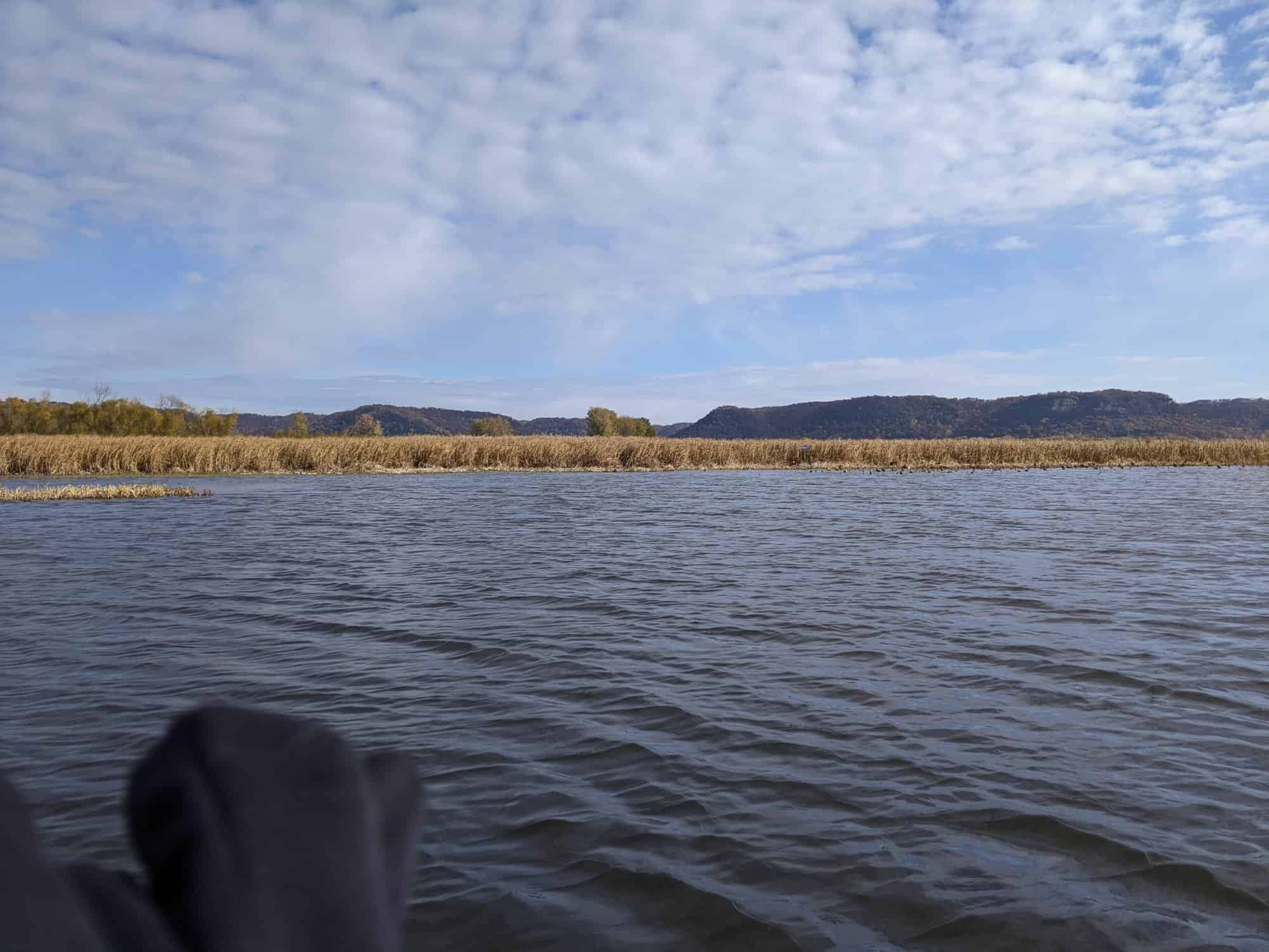 September bass fishing on the Mississippi River, landscape image with bluffs in background